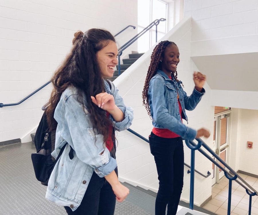 In the stairway, sophomores Leiale Demant and Amba May-Parker dance to “Renegade” for a TikTok on Dec. 12. Photo by Abby Asimos.