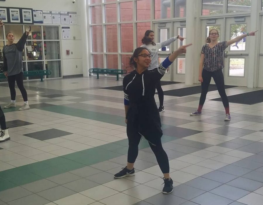 Leonyl Lazaga practices dance routine after school in the gym foyer on Dec. 12.