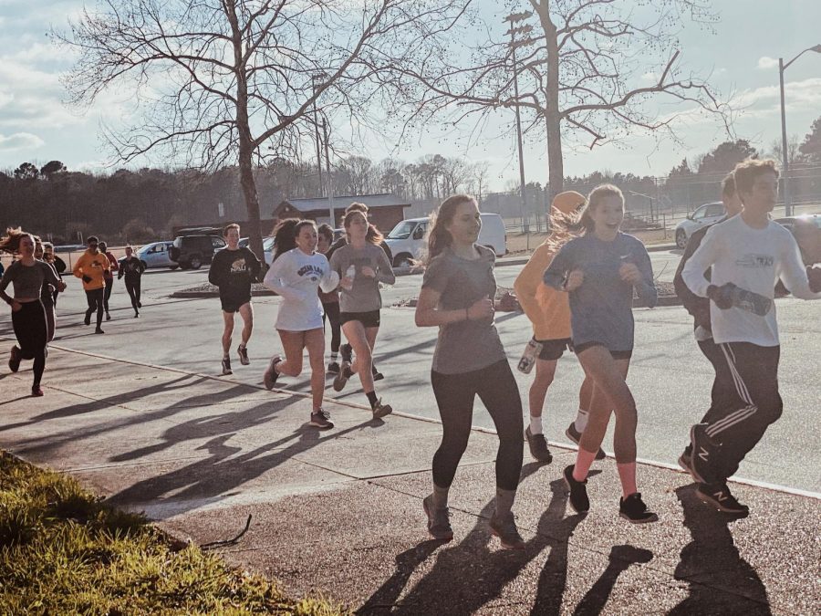 Indoor track runners Sophia Pommerank, Sophie Richardson, Cailan Juhas, Amanda Suh, and Drew Cavanaugh warm up for a short and fast sprint workout despite the chilly weather. Jan. 22, 2020.
