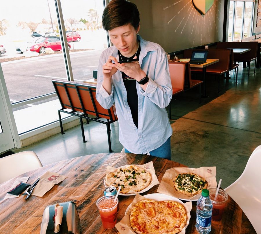 At Mod, Carson snaps some photos of his personalized pizza on Feb. 3.