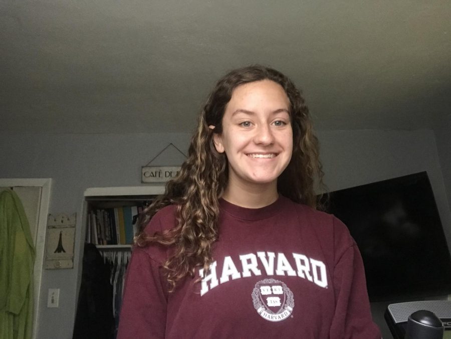Sophomore Celyna Kemp takes a photo in her Harvard University gear for Future Friday on March 27.