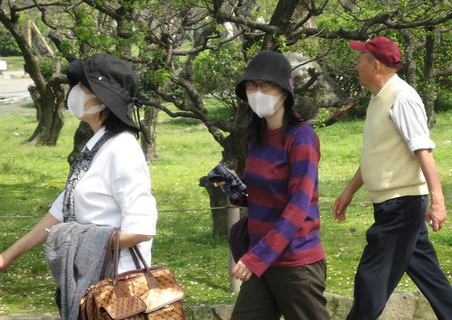 Individuals in Japan travel wearing masks to prevent the spread of illness. Photo sourced from Creative Commons. 