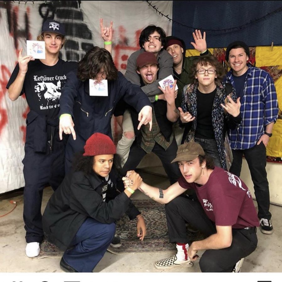 (From left to right) Lead guitarist Adam Allen, rhythm guitarist Brian Griffin, and vocals Kai Perry celebrate with local bands “Alpha,” “Squid?,” and “You’re Jovian” after their show at The Hurt House on March 6.
