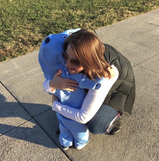 Carlin Conaway hugs the son of English teacher, Katie Anderson. Lane Anderson is dressed up as a dolphin for the 2019 Fall Fest. 