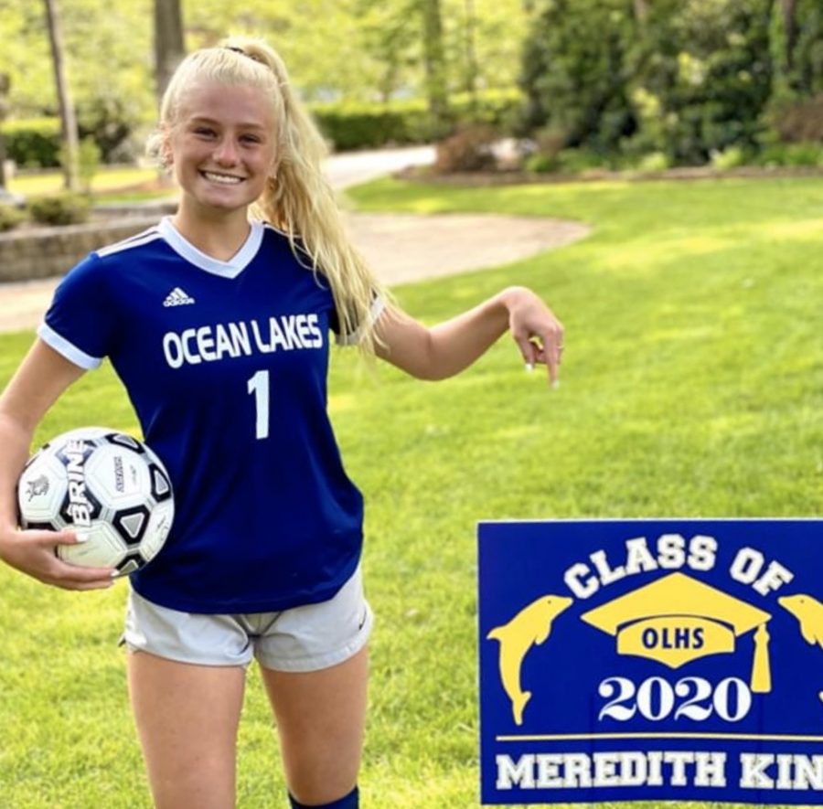 Senior Meredith King stands out in front of her yard with her graduation sign that was delivered on April 30 by teachers Gary Felch and John Kelley.