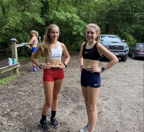 Sophia Pommerenk and Maggie Furco pose while completing their virtual workout in Seashore State Park. 