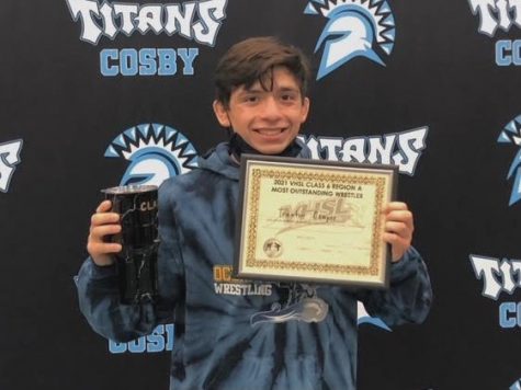 Trenton Campos beams while displaying his ‘Outstanding Wrestler’ award after regionals at Cosby High School on Feb. 15.

