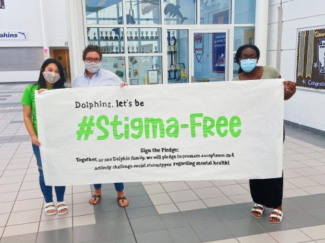 Club sponsor and school counselor Joanna Buonviri, Founder Nina Dao, and Co-President Chelsea Agyei hold up #EndTheStigma banner before it is hung near Counseling office on May 17.