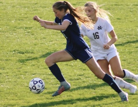 Senior Emerson Imbriale dribbles the ball down the field in the varsity soccer home opener against Kellam on April 30.
