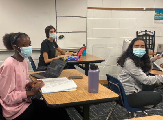 Yearbook staff members, Amba May Parker, Justine Newman, and Bella Kapp make edits and add final touches to the 2021 yearbook in Room 145.