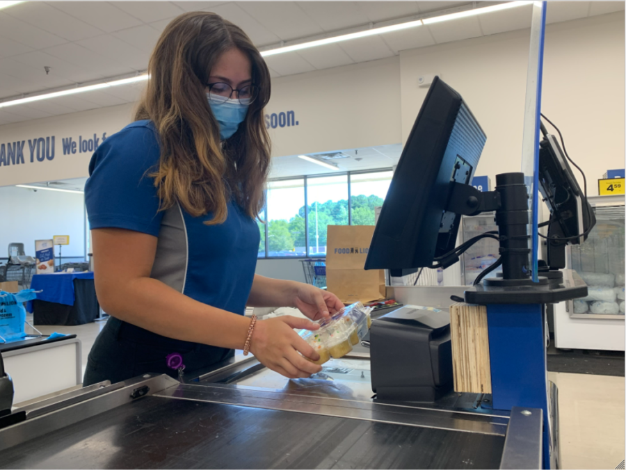 Senior Adriana Raimandi scans groceries at neighborhood food lion on Aug. 5. 
