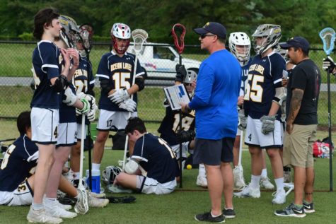 Boys lacrosse team huddles together after a challenging game against Grassfield at the Princess Anne Athletic Complex.
