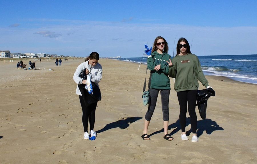 Surfrider Club members; Sydney Teeter, Lauren Meadows, and Riley Allen picking up trash at the Sandbridge Beach clean up on Nov. 14.