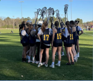 Girls lacrosse pump and cheer before their first season game against York at York High School on April 1, 2022. 