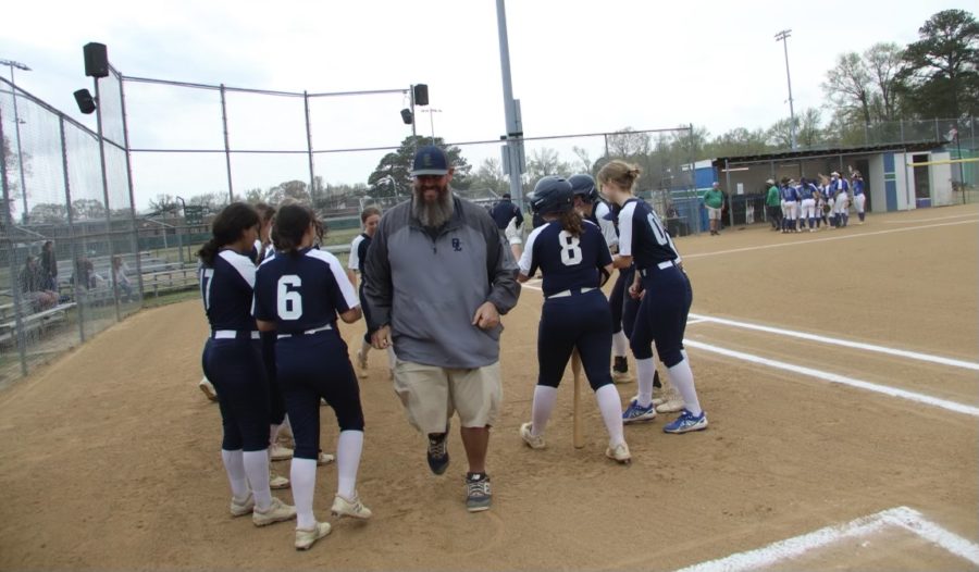 Varsity+softball%2C+along+with+their+coach%2C+Mike+Pollock%2C+performs+their+chant+and+routine+for+good+luck+at+the+start+of+their+game+against+Green+Run+High+School+at+their+softball+field+on+April+29%2C+2022.+
