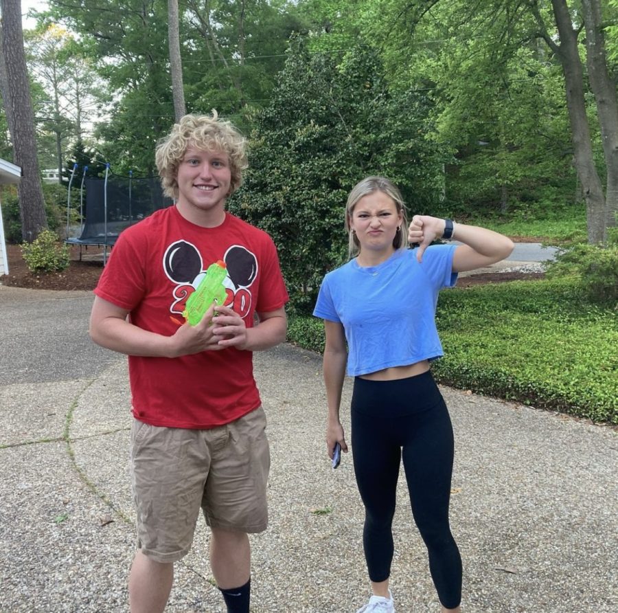 Seniors, LJ James and Sofia Ramos pose for the camera in front of Sofia’s house after a taxing water gun kill on Tuesday, May 17, 2022.