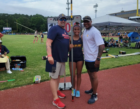 State Champion in Women’s Pole Vault, Brooke Gunter at Town Bank Field, Newport News in the Outdoor Track and Field Meet with coaches Ty Guzman and Brian Triolet.
