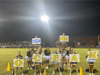 Varsity cheer team leads the student section in the “Ocean Lakes” cheer at the Ocean lakes vs. Kellam football game on Friday, Sept. 23, 2022.