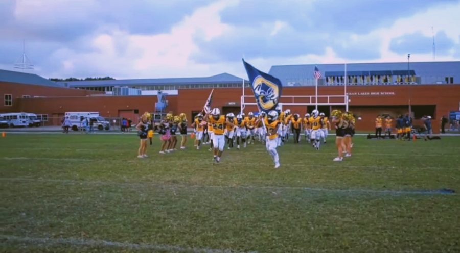 Dolphins varsity football rushes the field ready to take on the Kempsville Chiefs at Ocean Lakes High School on Friday, Sept. 9, 2022.