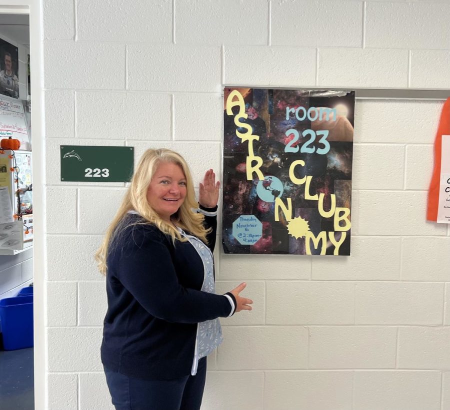 Astronomy club sponsor Michelle Bailey-Hennessey stands outside room 223 on Oct. 14, 2022, to display the poster she uses to advertise astronomy club. 