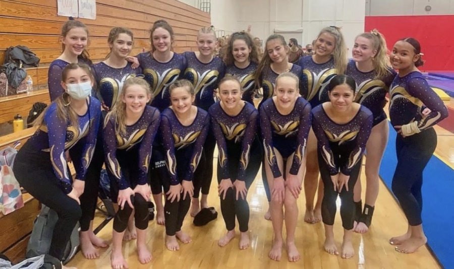 The gymnastics team gathers together after they were awarded first place at their last meet of the 2022 regular season against Salem and Princess Anne High School at Salem High School on Feb. 4, 2022.