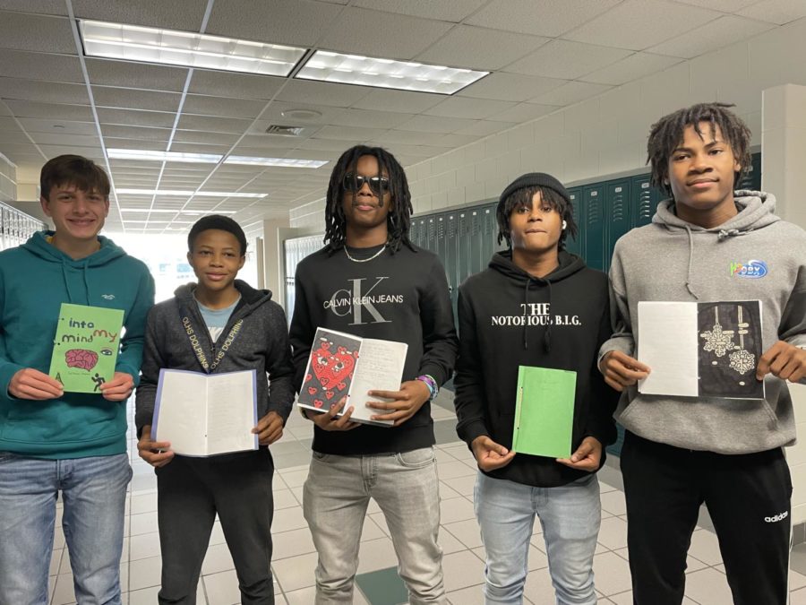 (From Left to Right) Sophomores Roman Chapman, Kaden Wellington, Tristan Savage, Josiah Wyatt, and Zayquan Reynolds from Thomas Stewarts fourth block class show off their hand-made poetry books in the English hallway on Dec. 16, 2022.