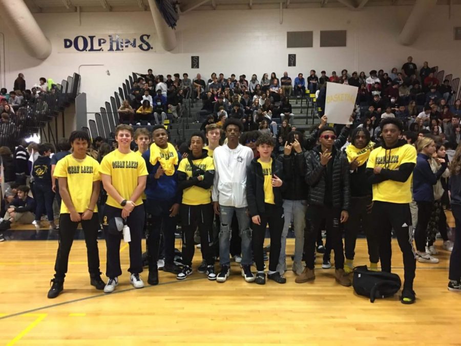 Boys' basketball teams represent themselves at the Winter sports pep rally in the Ocean Lakes gym on Friday, Dec. 16.