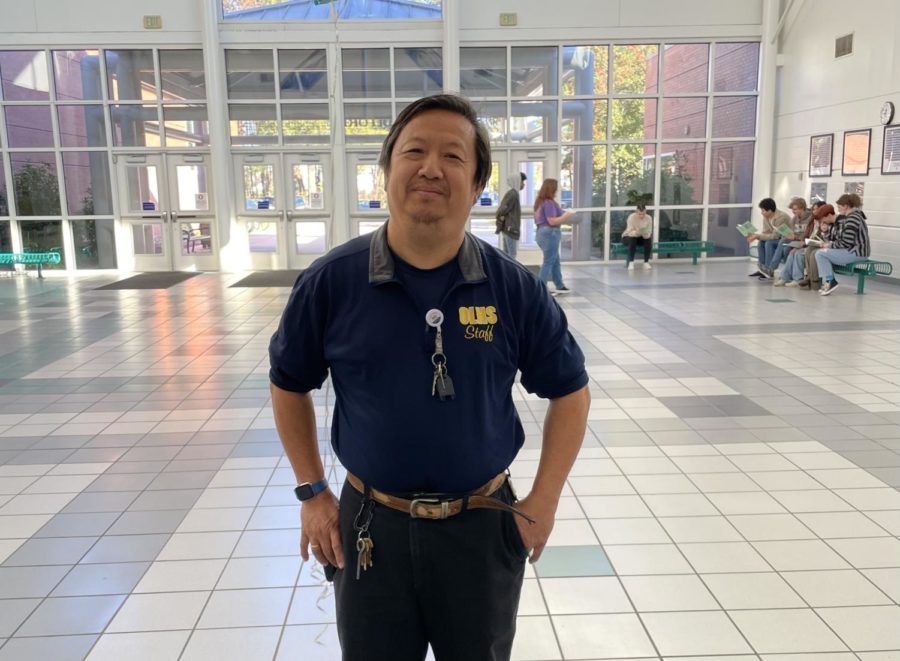 Ocean Lakes’ Custodian, Chi Ha, smiles outside of the cafeteria on his birthday, Nov. 23, 2022. 
