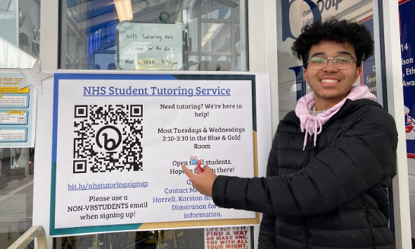 Tutor and NHS member Tyler O’Berry stands outside the Blue and Gold Room to promote tutoring services on Nov. 21.