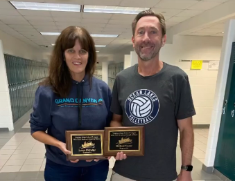 Laura Eldredge stands next to Micheal Nestor with her Virginia High School League Merit award she received on Nov. 7, 2022. 