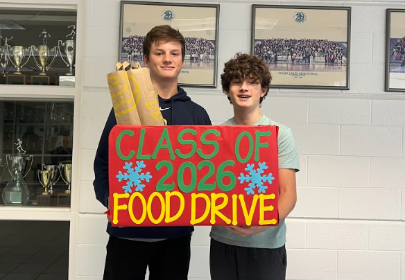 Freshmen Ryne Bracknell and Blake Stemple pose with class of 2026 food drive box donations on Dec. 9, 2022.
