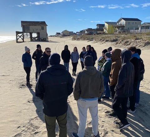Magnet Geology students listen as John McCloud speaks of beach replenishment on Dec. 1, 2022. 
