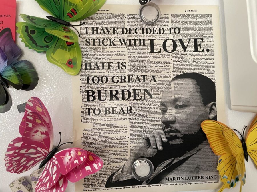 A poster which showcases Martin Luther King Jr.’s quote, “I have decided to stick with love. Hate is too great a burden to bear hangs on the side of a refrigerator surrounded by butterfly magnets on Jan. 14, 2023. 