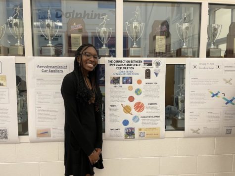 Senior Sonia Kekeh presents senior project about the connections between imperialism and space exploration at gallery night on Jan. 25, 2023 on Academic Street at Ocean Lakes High School. 