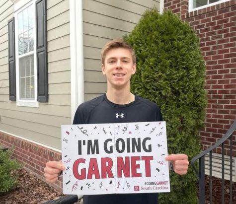 Senior Vincent Baker smiles in his front yard after receiving his early decision acceptance to the University of South Carolina on Dec. 14, 2022.