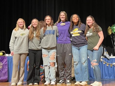 Softball seniors Rachel Monser, Caroline Burdsa, Calliope James, Ashley Bush, Nina Laungrath and Devin McCal smile for a picture after their signings on Feb. 1, 2023 in the auditorium. 
