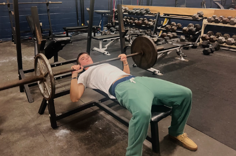 Senior Grayson Kidd works on his form while benching in the weight room on Jan. 26, 2023.