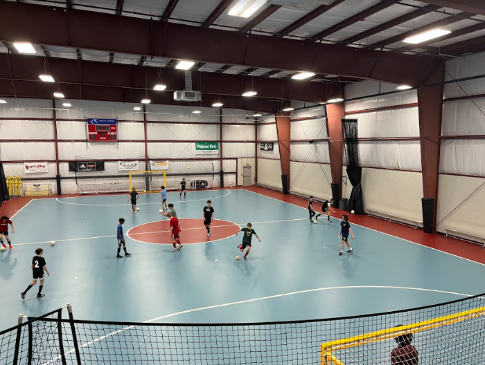 Members of the boys soccer team warmup for a day of futsal at the Beach FC Futsal Arena on Thursday Feb. 2, 2023. 
