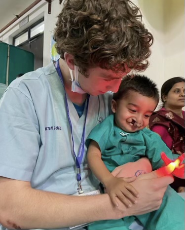 Senior Andrew Luksik entertains an Operation Smile patient on March 27, 2023 in a local hospital in Raipur, India. 