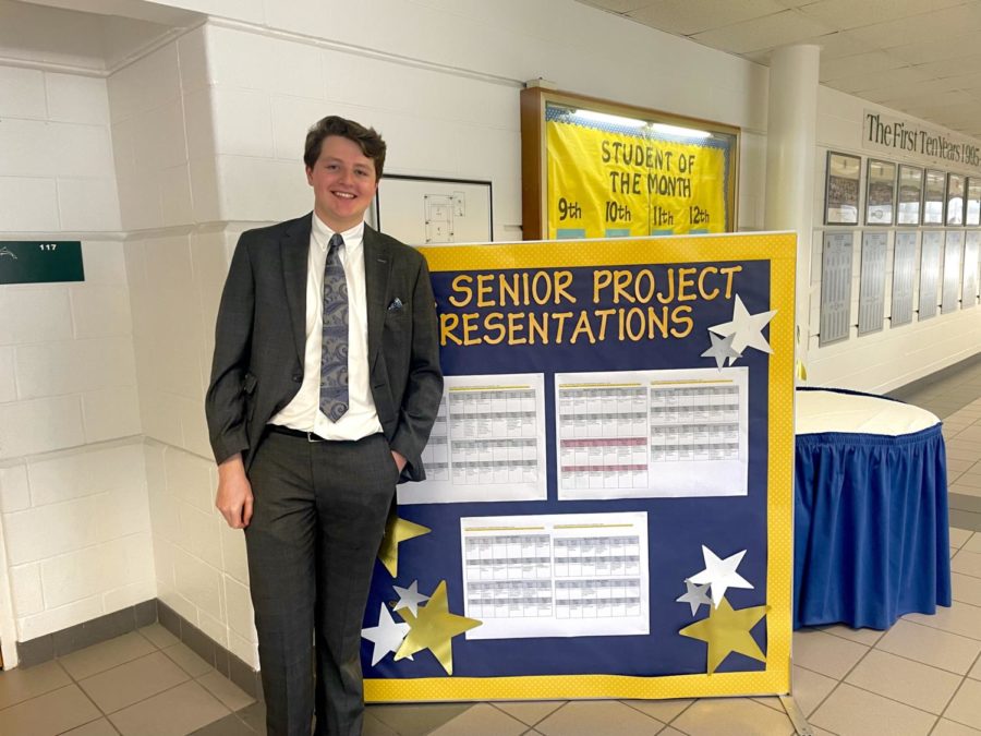 MSA senior Karstan Bock stands next to senior project board before his presentation on gamification on user satisfaction with an online educational tool on March 1, 2023. 