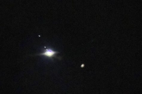 Jupiter and four of his moons shine through a telescope on Dec. 16, 2022.