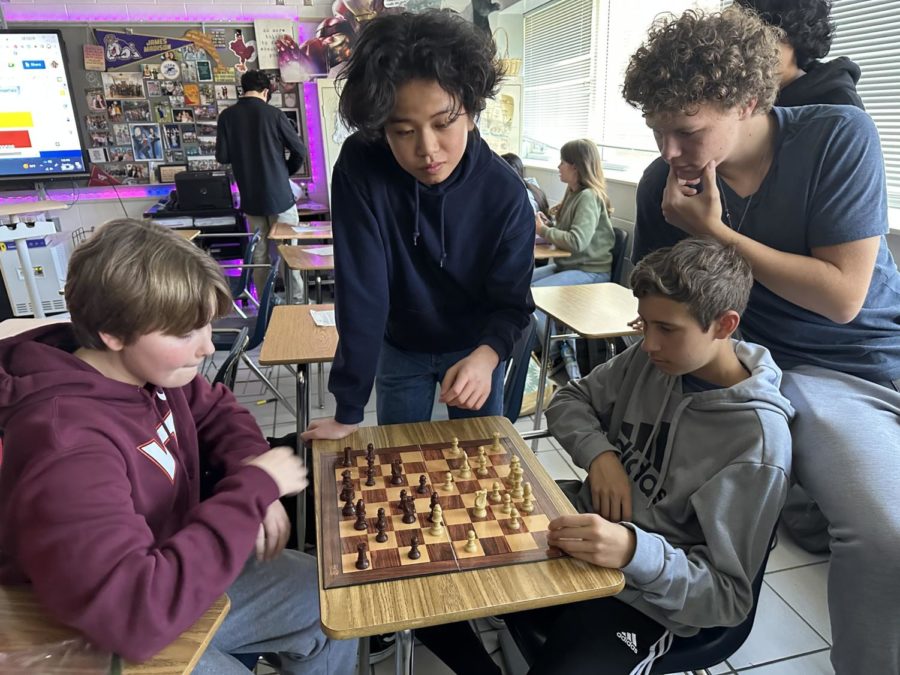 Freshmen Cooper Stuart, Bach Troung, Shane Six and William Yang play chess together on March 21, 2022.