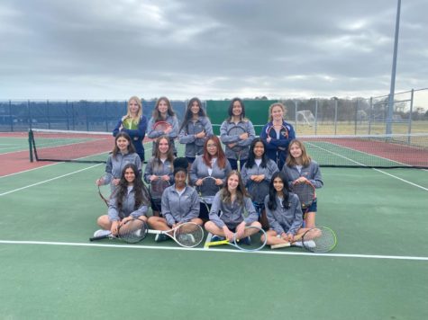 Members of the girls tennis team take their yearbook photo for the 2023 season on the Ocean Lakes Tennis Courts on Tuesday Feb. 28, 2023.