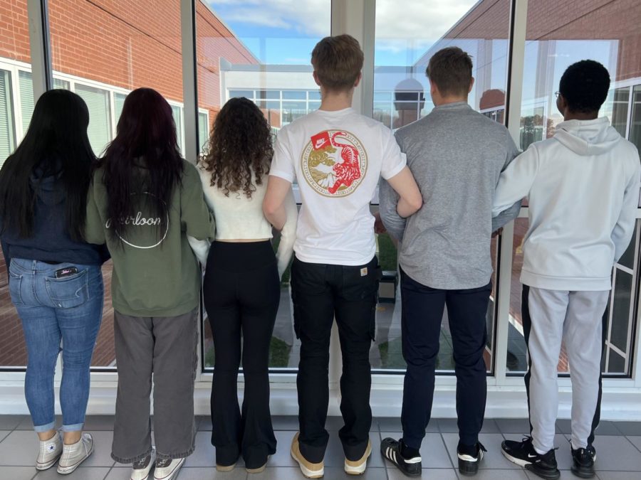 Seniors from AP English Literature and Composition each with different hair colors and types line up hand-in-hand March 8, 2023.