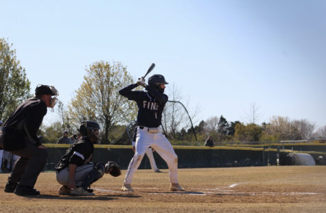 Colin Benson bats against Landstown in the second inning on March 15, 2023. 