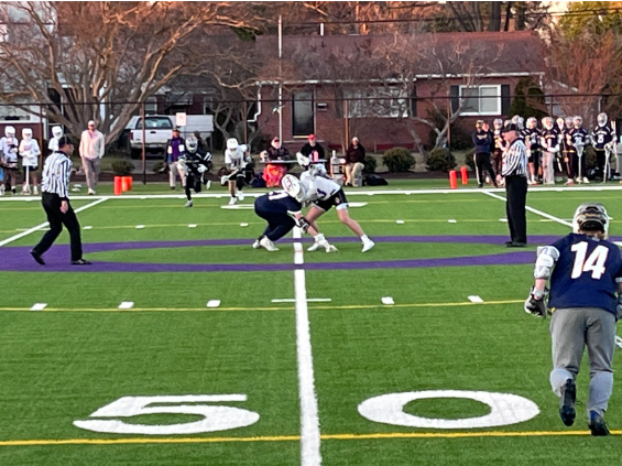 Senior Andrew Luksik battles in the faceoff against Norfolk Christian on March 20, 2023.
