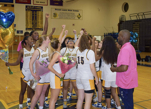 The girls basketball team gathers to celebrate senior night, one of the many events teams plan to celebrate their athletes. Picture was taken at Ocean Lakes High School on Feb. 13, 2023.