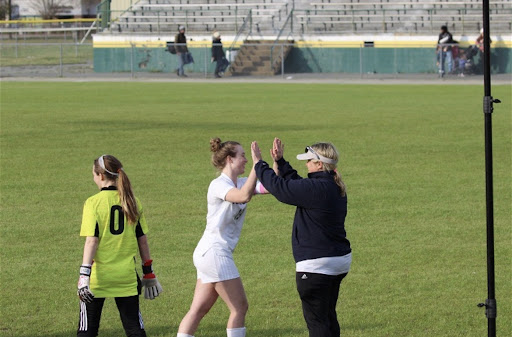 Sierra Clark high-fives her coach, Christine Thornton, during a soccer game against Great Bridge on Mar. 28, 2023