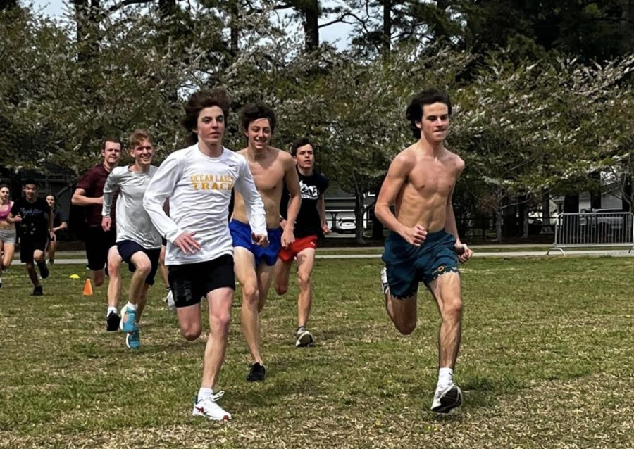 Distance runners Ben Labert, Preston Haney, Dylan Evans, Logan Hamilton, Roman Chapman and Skylar Pritchett practice at Redwing Park before a meet on April 3, 2023.