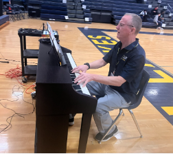 William Boardman practices the national anthem on the piano before the spring sports assembly in Ocean Lakes High auditorium on April 7, 2023.